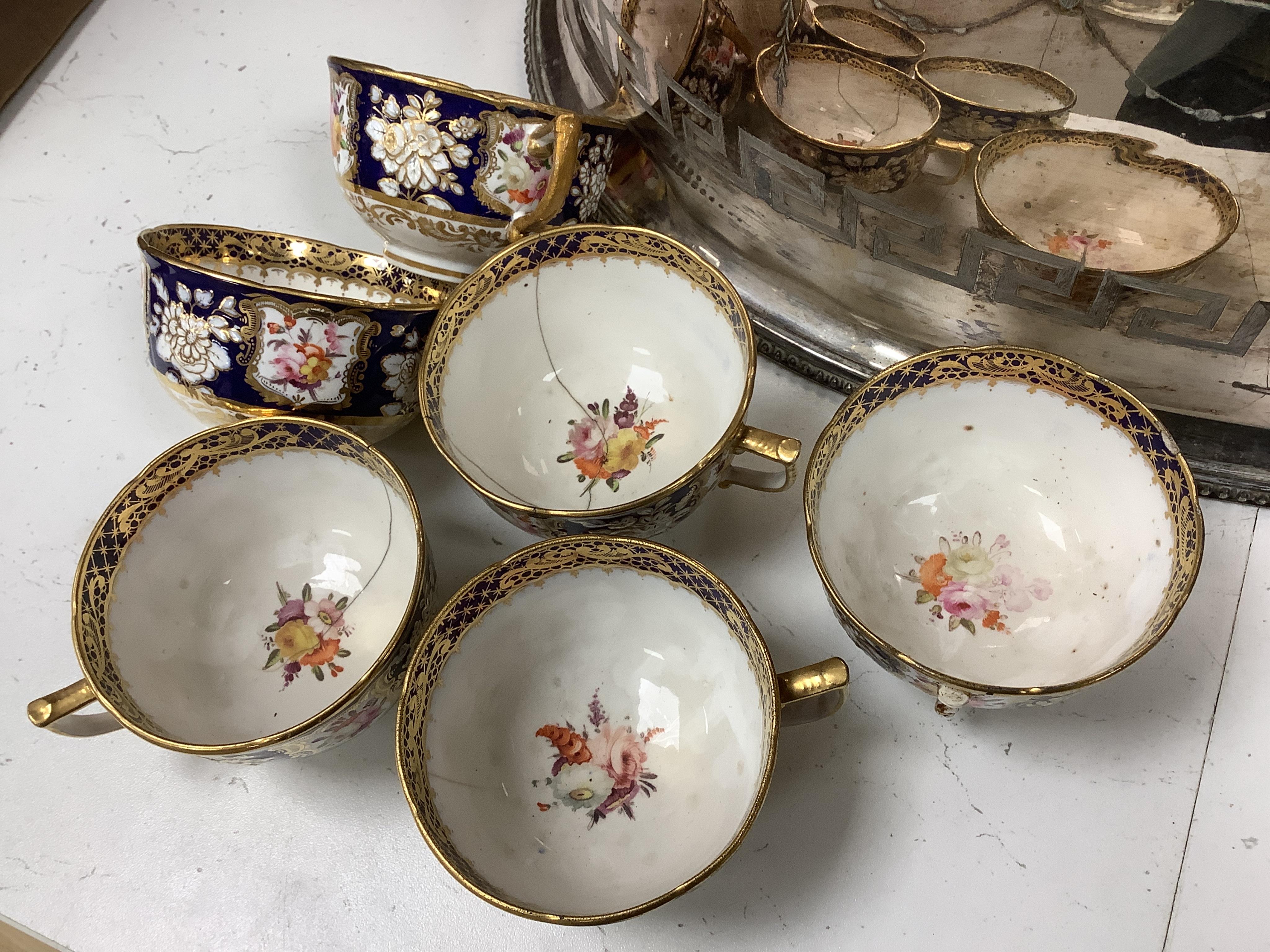 An early 19th century English porcelain tea service, possibly Coalport, moulded in low relief with floral reserves and cobalt blue border. Condition - varies